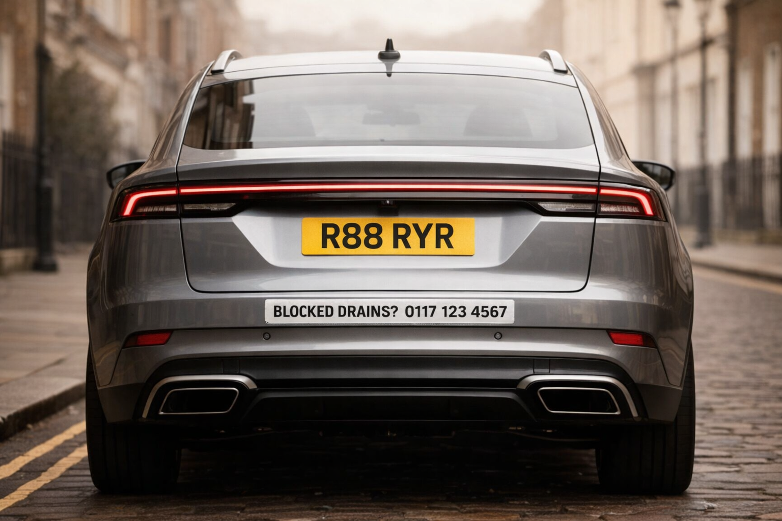 Rear of a car with a magnetic Rent Your Rear advert strip below the number plate